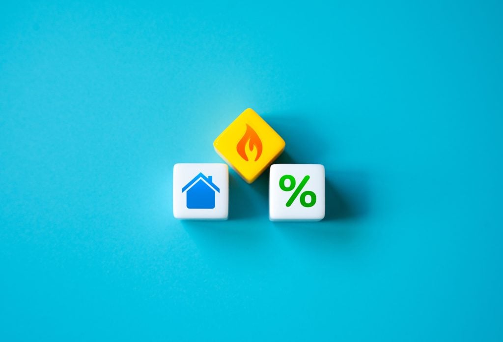 Icons representing housing, fire, and interest rates on a blue background.