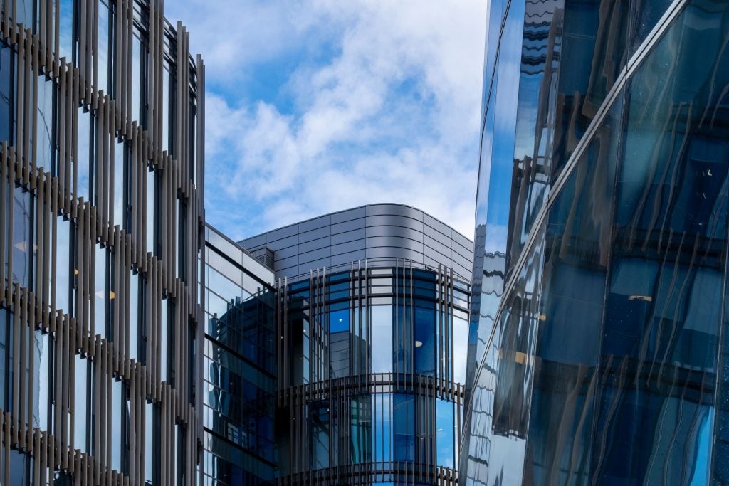 Modern UK office building with reflective glass facade, suitable for commercial property investment.