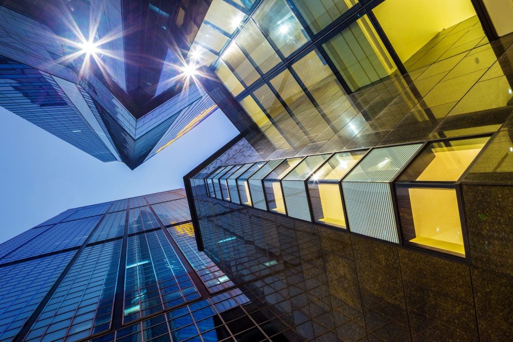 Contemporary office tower at night, representing premium commercial property in UK cities.