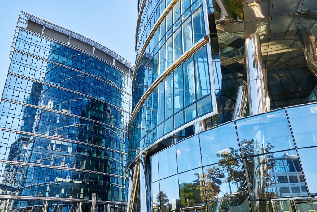 Contemporary office tower at night, representing premium commercial property in UK cities.